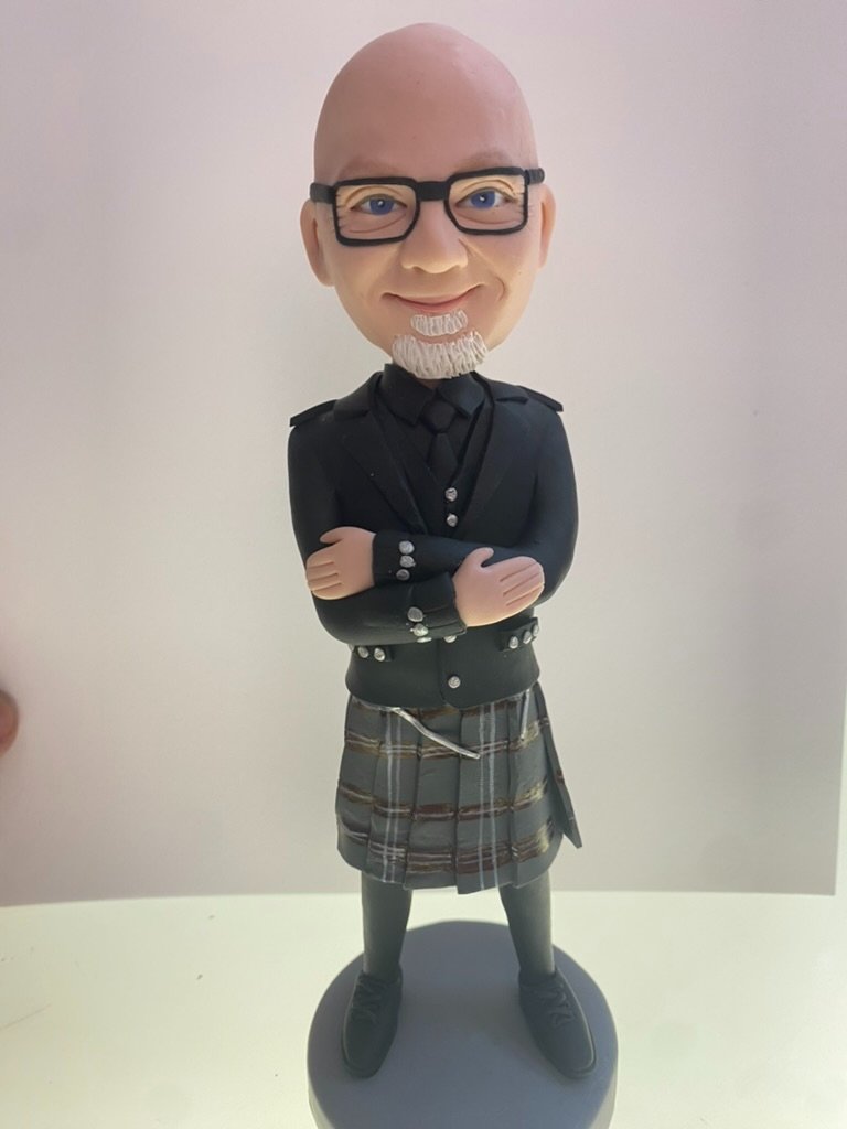 Bobblehead likeness of Stephen John in a kilt